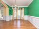 Elegant dining area featuring hardwood floors, chair rail, and natural light at 6123 Glen Manor Dr, Charlotte, NC 28269