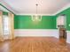 Spacious dining room with hardwood floors, and stylish light fixture at 6123 Glen Manor Dr, Charlotte, NC 28269