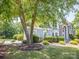 Beautiful home exterior with mature landscaping surrounding the front yard at 6123 Glen Manor Dr, Charlotte, NC 28269