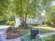 Charming home showcasing a well-manicured lawn, mature landscaping, and a mailbox at 6123 Glen Manor Dr, Charlotte, NC 28269