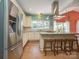 Gourmet kitchen showcasing granite countertops, stainless appliances, tiled backsplash, and a center island with stool seating at 6123 Glen Manor Dr, Charlotte, NC 28269
