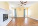 Bright living room with ceiling fan, fireplace and beautiful hardwood floors at 6123 Glen Manor Dr, Charlotte, NC 28269