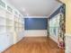 Bright living room with built-in shelving and large windows at 6123 Glen Manor Dr, Charlotte, NC 28269