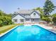 Beautiful pool with a putting green, lounge chairs, and patio furniture create an outdoor oasis at 6123 Glen Manor Dr, Charlotte, NC 28269