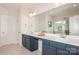Bathroom featuring double sinks, undermount cabinets, tile floors, and large mirror at 620 Baneberry Bluff Ct, Rock Hill, SC 29732