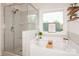 Modern bathroom with a glass-enclosed shower and separate soaking tub, illuminated by a large window at 620 Baneberry Bluff Ct, Rock Hill, SC 29732