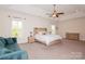 Spacious main bedroom with a tray ceiling, sitting area, and abundant natural light at 620 Baneberry Bluff Ct, Rock Hill, SC 29732