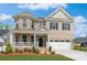 Beautiful two-story brick home featuring a welcoming front porch and well-manicured lawn at 620 Baneberry Bluff Ct, Rock Hill, SC 29732
