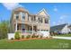 Charming brick home with a neatly landscaped front yard and inviting covered porch at 620 Baneberry Bluff Ct, Rock Hill, SC 29732