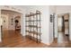 Hallway with wood floors featuring a modern shelving unit and open archway at 620 Baneberry Bluff Ct, Rock Hill, SC 29732