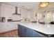 This modern kitchen features white cabinets, stainless steel appliances, and a blue island with a white countertop at 620 Baneberry Bluff Ct, Rock Hill, SC 29732