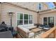 Inviting patio with string lights, comfortable seating, and a grill, perfect for outdoor entertaining at 620 Baneberry Bluff Ct, Rock Hill, SC 29732