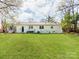 Large backyard featuring lush grass and the home's exterior at 6310 Welford Rd, Charlotte, NC 28211