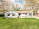 Charming one-story home featuring a lush green lawn and classic white exterior at 6310 Welford Rd, Charlotte, NC 28211