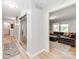 Bright hallway with modern flooring, leading to the living area and bathroom at 6310 Welford Rd, Charlotte, NC 28211