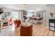 Open concept living space featuring an eat-in kitchen with stainless steel appliances and brick accent wall at 6310 Welford Rd, Charlotte, NC 28211