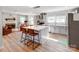 Open-concept kitchen with brick backsplash, island seating, and natural light at 6310 Welford Rd, Charlotte, NC 28211