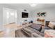 Spacious living area featuring a large sectional sofa, entertainment center, and view of the front entry at 6310 Welford Rd, Charlotte, NC 28211