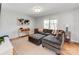 Comfortable living room with a large sectional sofa, ottoman, and bright natural light from a window at 6310 Welford Rd, Charlotte, NC 28211