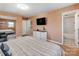 Bright main bedroom featuring a view of the ensuite bathroom and a large mirrored closet at 6310 Welford Rd, Charlotte, NC 28211