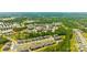 Aerial view showcasing a residential community with lush landscaping and a sparkling swimming pool at 637 Amber Meadows Way, Fort Mill, SC 29708