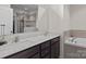 Elegant bathroom with double sinks, granite countertop, soaking tub, and tiled shower with glass door at 637 Amber Meadows Way, Fort Mill, SC 29708