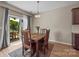 Cozy dining area with wooden table and chairs, sliding door access to patio with outdoor seating at 637 Amber Meadows Way, Fort Mill, SC 29708