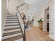 Inviting entryway with wood floors, staircase, and views of the kitchen and adjacent living spaces at 637 Amber Meadows Way, Fort Mill, SC 29708