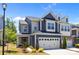 Charming two-story home featuring a two-car garage, blue siding, and a well-manicured front lawn at 637 Amber Meadows Way, Fort Mill, SC 29708