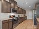 Gourmet kitchen featuring stainless steel appliances, dark wood cabinetry, and hardwood floors at 637 Amber Meadows Way, Fort Mill, SC 29708