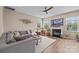 Bright living room with a fireplace, large windows, and a comfortable seating area at 637 Amber Meadows Way, Fort Mill, SC 29708