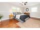 Cozy bedroom features warm hardwood floors, neutral walls, and ample natural light from windows at 7024 Rockledge Dr, Charlotte, NC 28210