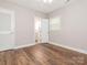 Inviting bedroom featuring wood flooring, neutral tones, and en-suite bathroom access at 7024 Rockledge Dr, Charlotte, NC 28210