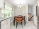 Cozy dining area adjacent to the kitchen with a modern chandelier at 7024 Rockledge Dr, Charlotte, NC 28210