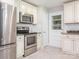 Well-maintained kitchen featuring stainless steel appliances and white cabinetry at 7024 Rockledge Dr, Charlotte, NC 28210