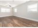 Spacious living room with wood floors, lots of natural light, and a ceiling fan at 7024 Rockledge Dr, Charlotte, NC 28210