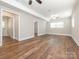Spacious living room features wood flooring, neutral paint, and natural light from the windows at 7024 Rockledge Dr, Charlotte, NC 28210