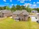 Aerial view of a brick home with a large green backyard and outdoor patio at 705 Brown Creek Dr, Matthews, NC 28104