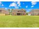 Large backyard of a brick home with lush green grass and mature trees at 705 Brown Creek Dr, Matthews, NC 28104