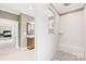 Bright bathroom with a walk-in shower, neutral tile, and a view into the bedroom at 705 Brown Creek Dr, Matthews, NC 28104