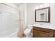 Full bathroom features a tub and shower combination, as well as a wood vanity and framed mirror at 705 Brown Creek Dr, Matthews, NC 28104