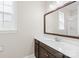 Bright bathroom featuring a sleek vanity with a modern sink, mirror, and a shower at 705 Brown Creek Dr, Matthews, NC 28104