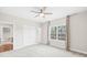 Spacious bedroom features a ceiling fan, large window, and ensuite bath at 705 Brown Creek Dr, Matthews, NC 28104