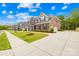 Brick home showcasing a long driveway and manicured lawn at 705 Brown Creek Dr, Matthews, NC 28104
