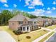 An aerial view of a brick home in a residential neighborhood with green lawns at 705 Brown Creek Dr, Matthews, NC 28104