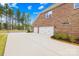 View of a brick home showing the spacious driveway leading to a three-car garage at 705 Brown Creek Dr, Matthews, NC 28104