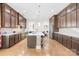 Large kitchen with dark wood cabinets, a center island, stainless steel appliances and hardwood floors at 705 Brown Creek Dr, Matthews, NC 28104
