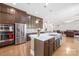 Modern kitchen island featuring stainless steel appliances, quartz countertops and hardwood floors at 705 Brown Creek Dr, Matthews, NC 28104