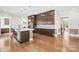 Open kitchen featuring a large island, stainless steel appliances, and dark wood cabinets for ample storage at 705 Brown Creek Dr, Matthews, NC 28104