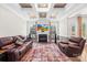 Comfortable living room boasts a fireplace, coffered ceiling, and plush leather seating at 705 Brown Creek Dr, Matthews, NC 28104
